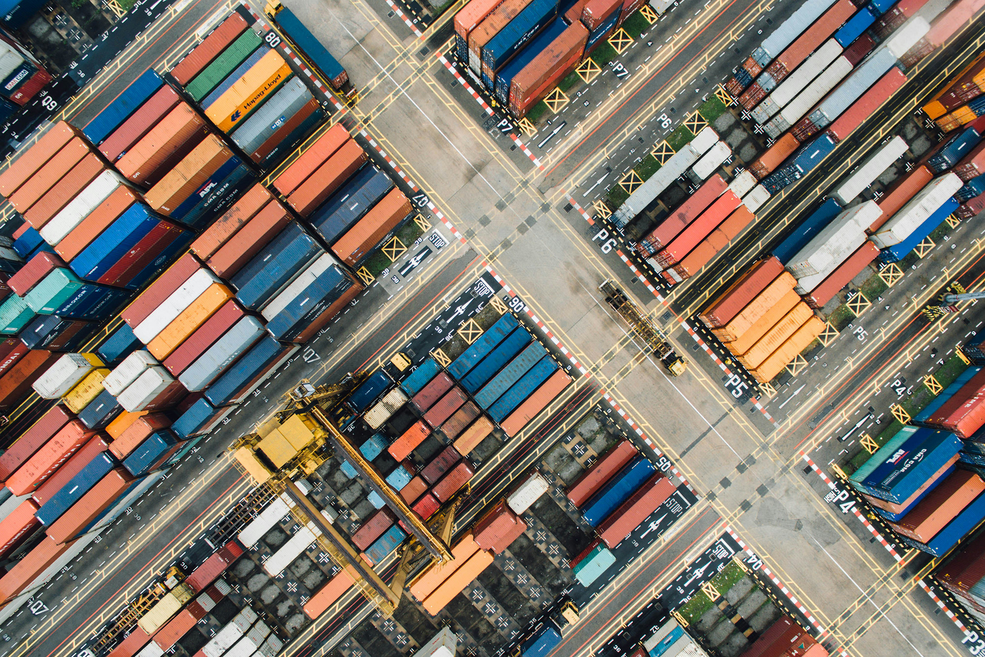Shipping containers stacked in a port, seen from above